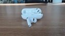 apple airpods pro 3 open on table with earbuds coming out of the case