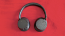 Sony WH-CH720N Noise Canceling Wireless Headphones on red fabric