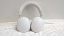 white sonos ace headphones on a white fuzzy blanket