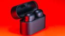black sony wf-1000xm6 earbuds on red background