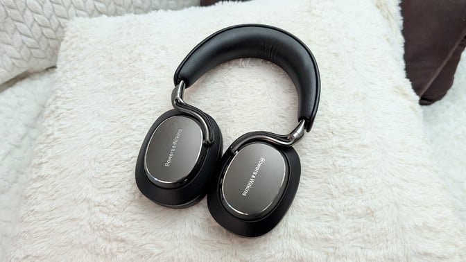 Bowers & Wilkins Px8 S2 headphones on a fuzzy white pillow