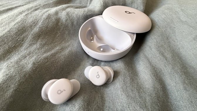 lilac soundcore sleep a30 special earbuds and case on blue blanket
