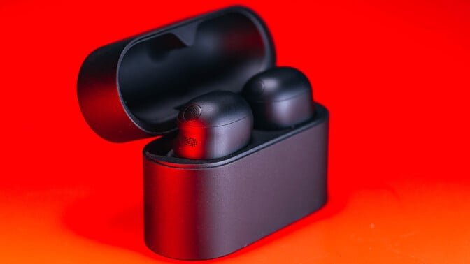 black sony wf-1000xm6 earbuds on red background